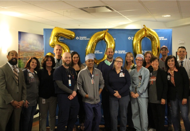 Healthcare team celebrating 500 milestone achievement Healthcare team celebrating 500 milestone achievement